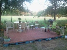 an outdoor patio with chairs and tables on it