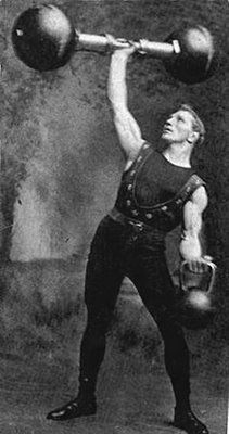 an old black and white photo of a man lifting a barbell over his head