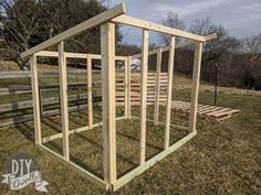 a building made out of wooden pallets in the grass