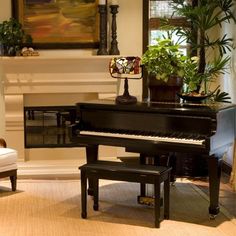 a living room filled with furniture and a piano in front of a painting on the wall