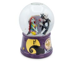 a snow globe with a skeleton and jack skellingy on it's side