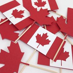 red and white canadian flags on sticks with toothpicks in the shape of maple leaves