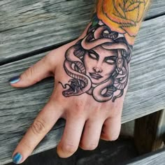 a woman's hand with a tattoo on it and a rose in the middle