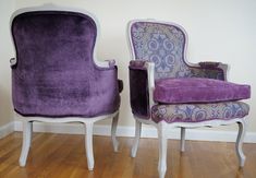 two purple chairs sitting next to each other on top of a hard wood floor