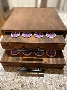 a wooden box with four cups and chopsticks in it on top of a table