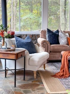 a living room filled with furniture and lots of windows