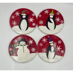 four plates decorated with penguins and snowflakes