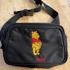 Vintage Disneyland Super Rare Winny The Pooh Bear Body Bag. Like New Condition Without Tags. Can Be Worn Cross Body Or Fannie Style. This Looks Like It Was Never Worn. Look At That Vintage Disneyland Tag!!!! Black Rectangular Bag With Embroidered Logo, Everyday Black Shoulder Bag With Embroidered Logo, Black Shoulder Bag With Embroidered Logo For Everyday, Travel Crossbody Bag With Embroidered Logo, Vintage Disneyland, Disney Bag, Pooh Bear, Body Bag, Winnie The Pooh