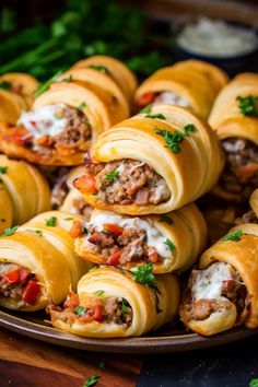 a plate filled with meat and cheese wrapped in tortillas