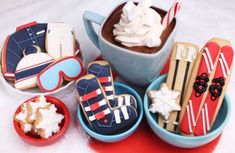 several decorated cookies in bowls on a table