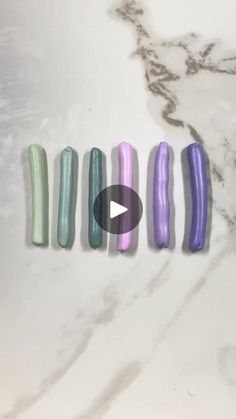 five different colors of nail polish sitting on top of a marble counter