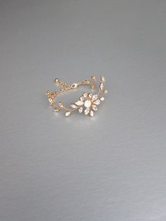 "This delicate floral bracelet is made with beautiful opal and clear Swarovski crystals. The bracelet measures 3/4\" wide in the center and it will fit 6\" to 8\" wrist. Available in gold or silver finish. - For the matching earrings please take a look here: https://www.etsy.com/listing/573107946/opal-bridal-crystal-earrings-swarovski?ref=shop_home_active_1 - For the matching headpieces please take a look here: https://www.etsy.com/listing/595318080/swarovski-crystal-bridal-hair-vine?ref=shop_ho Adjustable Gold Bracelet With Cubic Zirconia For Wedding, Rose Gold Cubic Zirconia Bracelet For Weddings, Rose Gold Cubic Zirconia Wedding Bracelet, Wedding Rose Gold Bracelet With Cubic Zirconia, Delicate Gold Bracelets For Wedding, Delicate Rose Gold Bracelet For Wedding, Delicate Rose Gold Wedding Bracelet, Gold Crystal Bracelet For Wedding, Dainty White Crystal Bracelet For Wedding