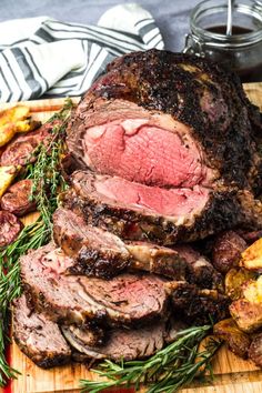 roast beef with rosemary garnish on a cutting board