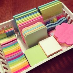 a box filled with lots of different colored cards and boxes on top of each other