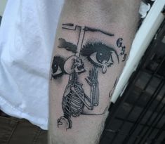 a man's leg with a black and white tattoo on it, depicting an eye