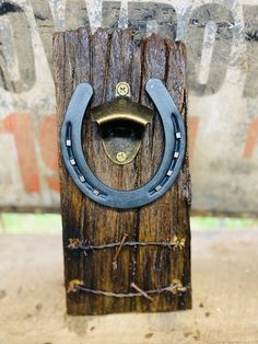 an old wooden post with a metal ring on it