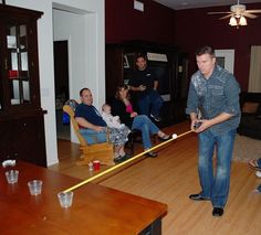 a group of people in a living room playing video games