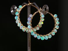 "THE JEWELRY IS SHIPPED via DHL EXPRESS (2-5 days delivery door to door). THE DHL SHIPPING COST IS INCLUDED IN THE PRICE. The Elixir Earrings - Solid Gold 14K Ethiopian Welo Opal Wire Wrapped Gemstone Hoop Earrings ► Measurements / Details: - Length of the hoops including Opals: 1.18\" (~3 cm), length of the gold hoops only: 1 inch - Gold: Solid Gold 14K, stamped inside the spiral of the hoops ► Hoop Sizes: - 0.75 inch - small hoops, excellent for everyday - 1 inch - as you see in the photos, cl Festive Fusion Style Round Hoop Earrings, Gold Fusion Hoop Earrings For Celebration, Festive Small Hoop Earrings For Pierced Ears, Handmade Hoop Earrings For Celebration, Hoop Earrings For Pierced Ears For Celebration, Yellow Gold Round Hoop Earrings For Celebration, Handmade Festive Hoop Jewelry, Wire Wrapped Yellow Gold Hoop Earrings, Anniversary Festival Hoop Earrings