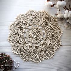 a white doily sitting on top of a wooden table