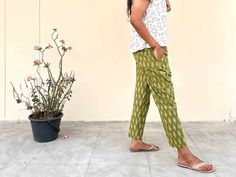 These 100% cotton straight-legged crop pants feature a comfortable paper bag-style elastic waist and two pockets. They are made from handloom Ikat fabric crafted in Telangana, India. If you are looking for something as soft and comfortable as sweatpants, without sacrificing an inch of style, these are your new go-to pants! They are guaranteed to become the most versatile item in your closet. Traditional Cotton Pants For Loungewear, Traditional Cotton Lounge Pants, Green Cotton Harem Pants For Loungewear, Casual Green Cotton Harem Pants, Relaxed Fit Cotton Harem Pants With Side Pockets, Cotton Harem Pants With Side Pockets And Relaxed Fit, Cotton Harem Pants With Side Pockets, Green Cotton Harem Pants With Elastic Waistband, Green Cotton Ankle-length Harem Pants