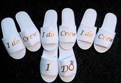 six pairs of white slippers with i do crew written on them