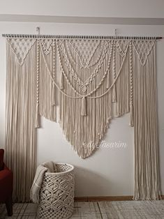 the wall is decorated with macrami and tassels for decorating it