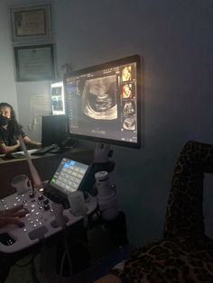 a woman is looking at an x - ray image on the monitor in her office