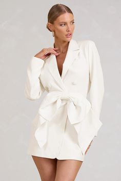 Delight every guest at that upcoming wedding or special event in our bow-embellished blazer dress, Prized . Made to rival any party gift, thislong-sleeved staple comes tailored in a double-breasted silhouette closed by four covered buttons. We'd prefer to style this white mini dress timelessly with strappy stilettos and a few gold accents.     Features    -   Premium stretch crepe    -   Blazer style    -   Peak lapels    -   Welt pocket    -   Long sleeves    -   Tailored fit    -   Double-breasted    -   Covered button closure    -   Detachable bow belt    -   Mini length     Sizing & Fit  Model is 5'8" and wears UK size 8 / US size 4       Product Information    Designed exclusively by Club L London    Fully lined with good stretch    Premium crepe in White (90% Polyester, 10% Elastane) White Blazer Dress, Mini Dress With Bow, Embellished Blazer, Midi Bridesmaid Dress, Club L London, Blazer Mini Dress, Crepe Blazer, Blazer Style, Strappy Stilettos