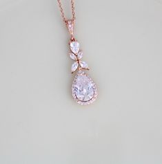 Rose gold Bridal necklace sparkles beautifully with Swarovski Pure Brilliance stones. Delicate and perfect for any bride ! Created with varied sizes of pear cut and marquise cubic zirconia stones. Necklace measures 16 inches and extends to 18 inches Pendant measures 1.5 inch x 1/2 inch Matching pieces: https://www.etsy.com/listing/497189638/rose-gold-bridal-earrings-long-wedding?ref=shop_home_active_1 https://www.etsy.com/listing/497195108/rose-gold-bridal-bracelet-crystal?ref=shop_home_active_1 Rose Gold Teardrop Bridal Necklace Gift, Rose Gold Teardrop Bridal Necklace, Rose Gold Drop Necklace For Wedding, Wedding Rose Gold Dangle Necklaces, Delicate Rose Gold Drop Necklace For Wedding, Gold Pear-shaped Drop Necklace For Wedding, Rose Gold Teardrop Drop Necklace For Wedding, Gold Teardrop Pendant Necklace For Wedding, Gold Teardrop Pendant Drop Necklace For Wedding