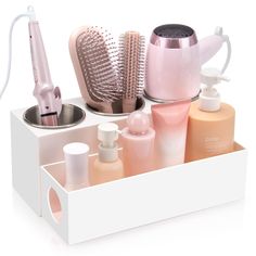 an assortment of beauty products displayed in a white container with hairdryer and brush