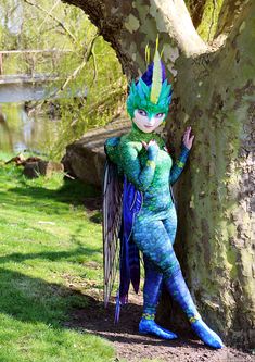 a woman dressed as tooth fairy standing next to a tree