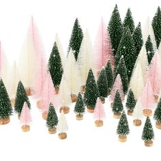 a group of small christmas trees with pink and white decorations on them, all lined up in rows