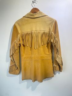 Vintage Suede Fringe Jacket. Super unique, fits like a small. Leather on top and suede on bottom with horn buttons and fringe throughout. Light wear on the suede. Approximate measurements:Arm to arm: 18"Length: 29" Leather Tassel Outerwear For Fall, Fall Leather Tassel Outerwear, Fitted Fall Outerwear With Tassels, Fall Leather Jacket With Tassels And Long Sleeves, Winter Leather Outerwear With Tassels, Winter Leather Tassel Outerwear, Long Sleeve Outerwear With Tassels For Rodeo, Winter Leather Jacket With Tassels, Western Style Long Sleeve Outerwear With Tassels