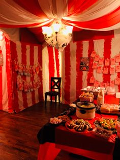 a red and white striped room with food on the table