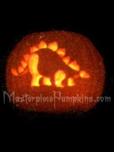 a pumpkin carved to look like a dinosaur