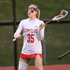 a female lacrosse player in action on the field