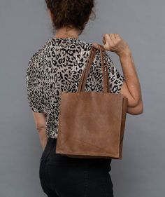 Check out other colors of this bag style here:https://www.etsy.com/shop/bags1and1stuff?ref=hdr_shop_menu&section_id=15504059A small leather tote to use when going out, this is what makes this bag worth purchasing for your own use. This simple leather tote is made out of leather and is sure to suit the outfit you'll be wearing for the party or any special occasion you'll be attending. Though it is small in size, this small black bag is sure to maximize your look as it is able to give the best Plain Tote, Money Smart, Trendy Tote Bags, Simple Leather, Small Tote Bag, Brown Tote, Brown Handbag, Evening Handbag, Mini Tote Bag