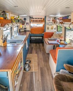 the inside of a camper with wood flooring and blue walls is shown in this image