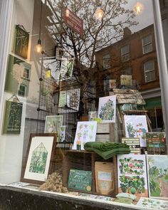 a store front window filled with lots of cards and greetings on the windowsill