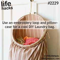 a laundry bag hanging from the side of a door with text that reads, use an embroidery loop and pillow - case for a cool diy laundry bag