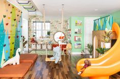 a child's playroom with swings, toys and other items in it that are brightly colored