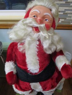 a santa clause doll with his mouth open