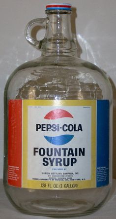 a bottle of pepsi cola fountain syrup sitting on a counter