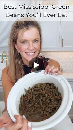 a woman holding a bowl full of green beans with the words best mississippi green beans you'll ever eat