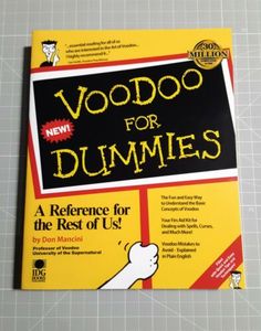 the book voodoo for dummies by don munnii is on top of a cutting board