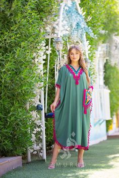 Egyptian Kaftan dress is perfect for the summer. Feel like a Mediterranean queen with the flowing vibrant monotone embroidery that strikes memories of your favorite getaway. The dress is made of Egyptian cotton that has a soft feel to it so you will surely feel comfortable and royal in it. You can wear this Kaftan practically anywhere and for any occasion. You can dress it up with a pair of heels and strut like an Egyptian queen at any gathering, resort, or party. Or you can dress it down with a Green V-neck Tunic For Beach, Bohemian Thobe For Beach Eid, Bohemian Thobe For Beach And Eid, Green V-neck Kaftan For Vacation, Bohemian Thobe For Beach Eid Celebration, Green Kaftan For Vacation And Eid, Green Kaftan For Eid Vacation, Traditional Green V-neck Tunic, Green Tunic For Eid