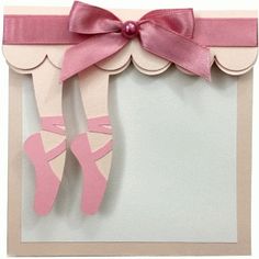 a card with pink ballet shoes and a ribbon on it's edge, in front of a white background