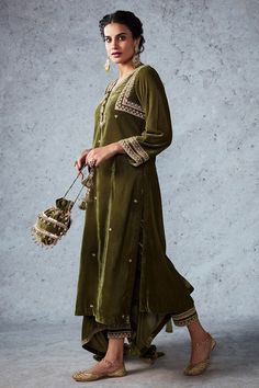 Olive green velvet kurta with aari and sequin embroidery. Comes with straight pants and dupatta.
Component: 3
Pattern: Embroidery
Type Of Work: Aari and Sequin
Neckline: V neck
Sleeve Type: Full
Fabric: Velvet
Color: Green
Other Details: 
Dupatta with embroidered border
Side slits
Button detail in front
Closure: Hook front
Note: Potli bag carried by the model is not for sale
Occasion: Puja - Aza Fashions Velvet Kurta, Velvet Embroidery, Kurta Pant Set, Velvet Suit, Bridal Photoshoot, Indian Fashion Designers, Kurta With Pants, Desi Fashion, Kurta Designs