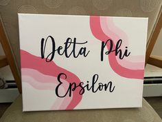 a canvas with the words delta phi epsion painted on it