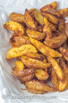 fried plantains on a white plate with seasoning sprinkled in brown sugar